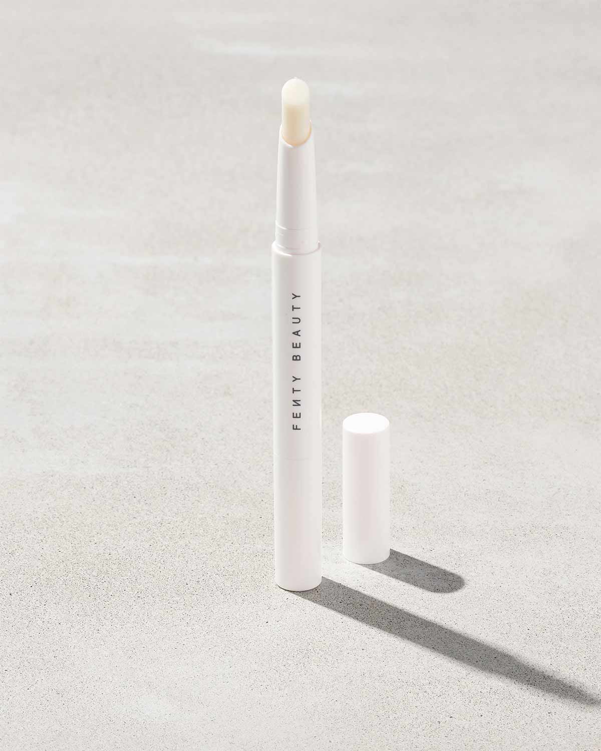 Brow MVP Sculpting Wax Pencil standing upright with the cap off and the brow wax twisted up.