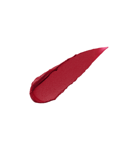 A smear of Fenty Icon Velvet lipstick in red color on a translucent background.