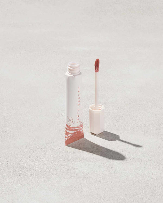 Open tube of Pro Kiss'r Luscious Lip Balm in shade Latte Lips on grey background.