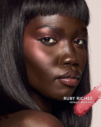 deep skin toned model wearing killawatt freestyle highlighter in shade ruby richez
