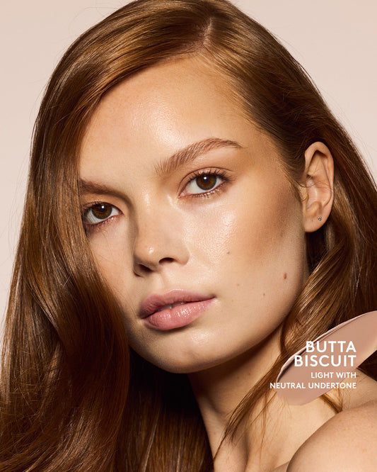 Light skin tone model wearing cheeks out bronzer in shade butta biscuit.