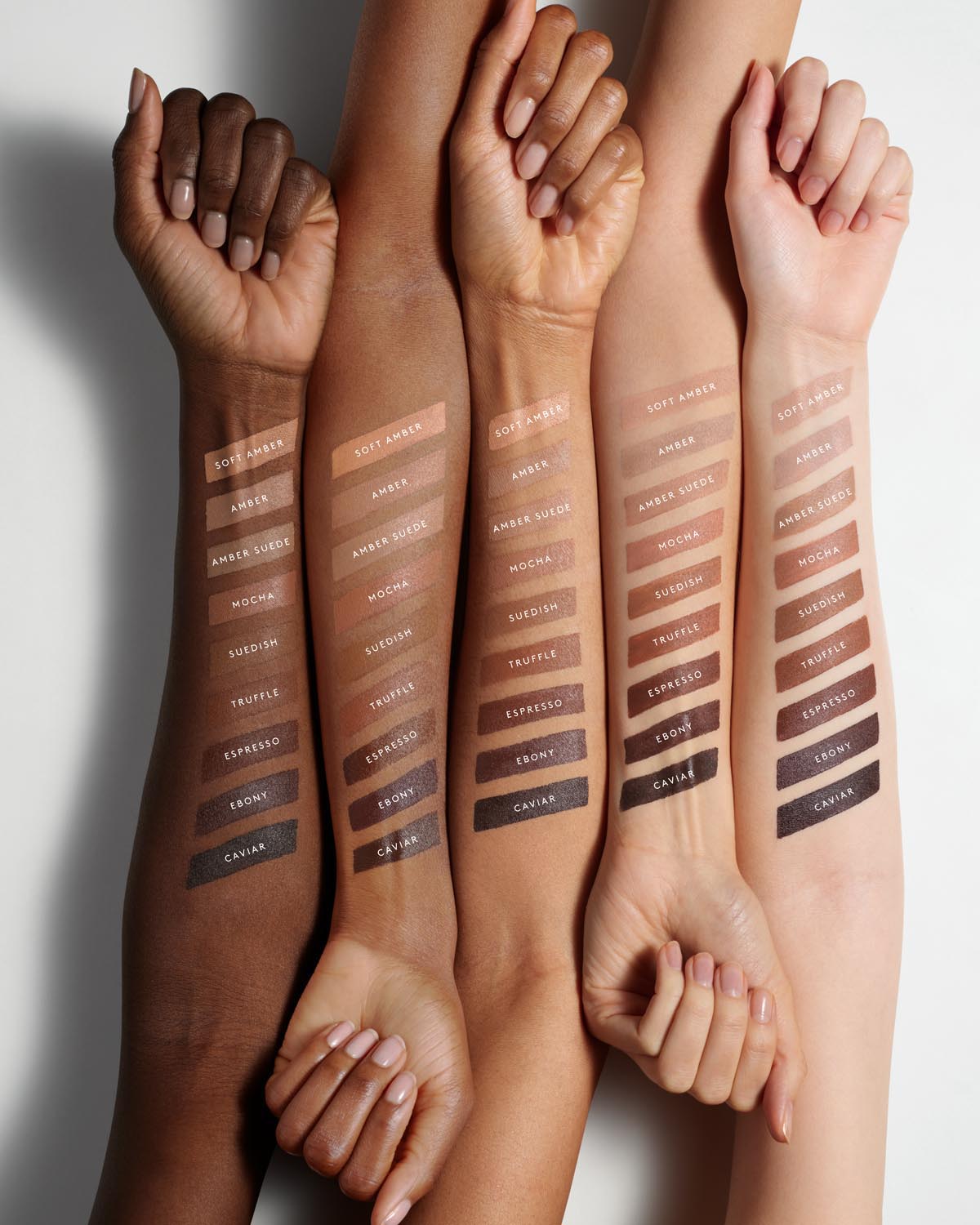 Arms of five models with different skin tones showing the nine shades of Match Stix Contour Skinstick on each arm.