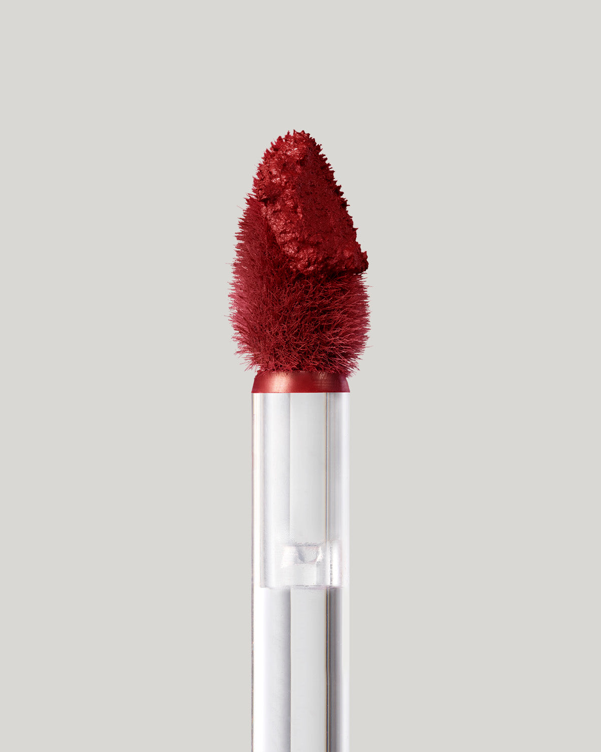 Close-up of of a Fenty Icon Velvet lipstick wand on a light background.