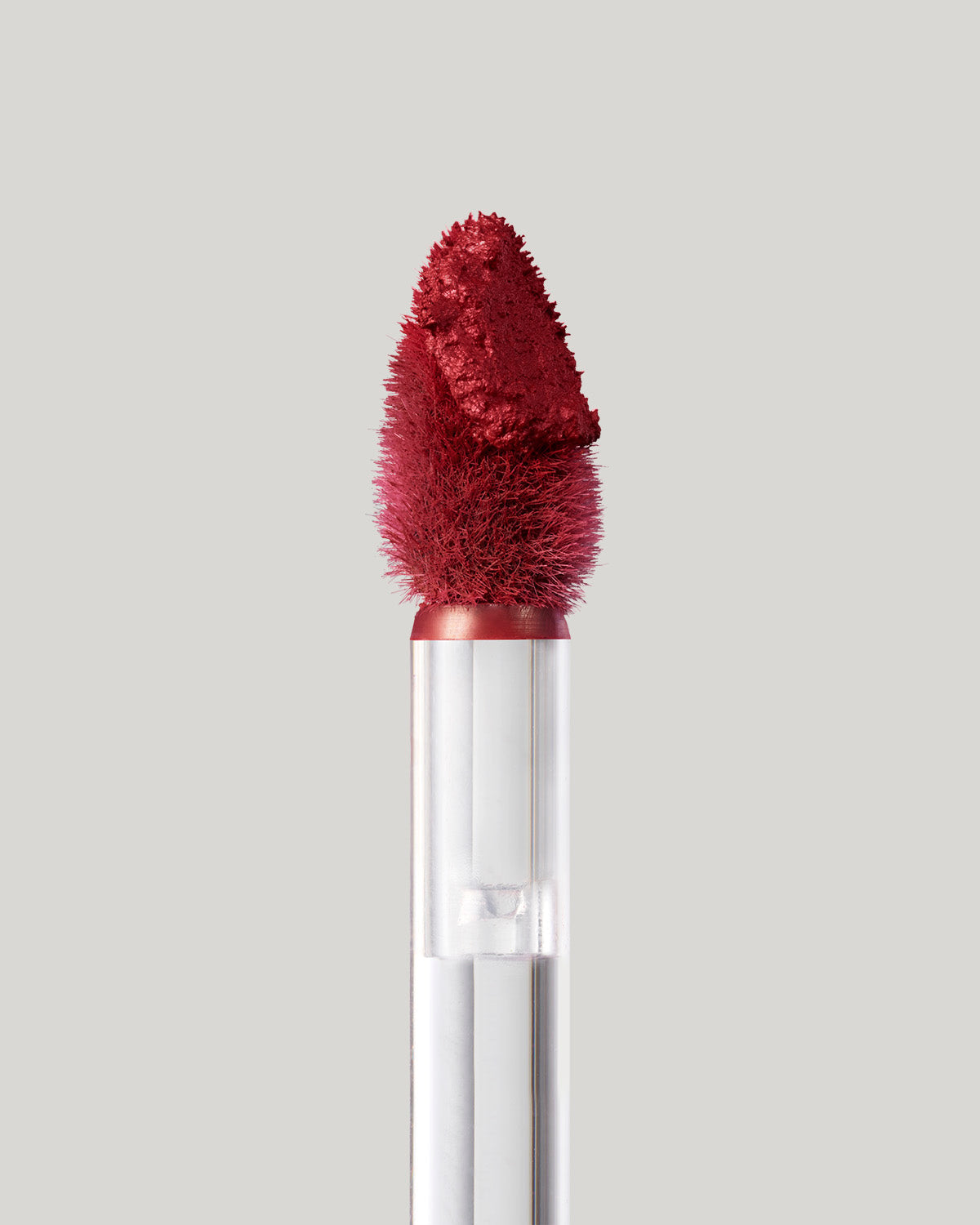 Close-up of of a Fenty Icon Velvet lipstick wand on a light background.