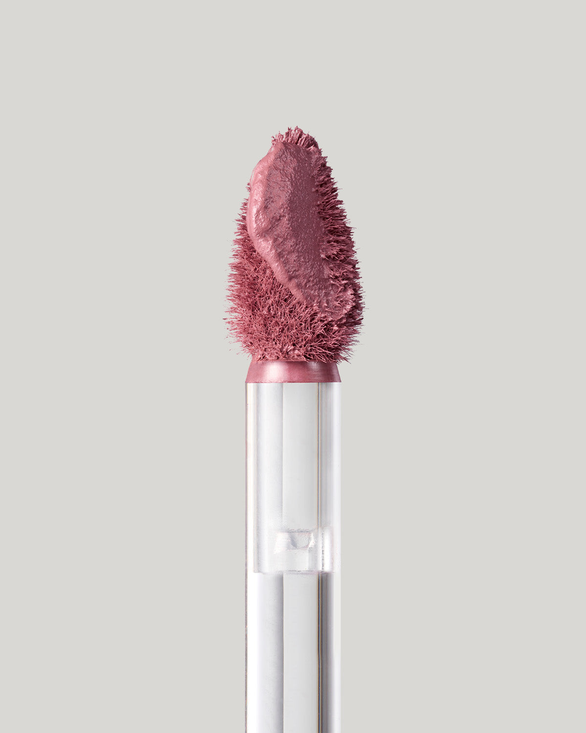 Close-up of of a Fenty Icon Velvet lipstick wand on a light background.